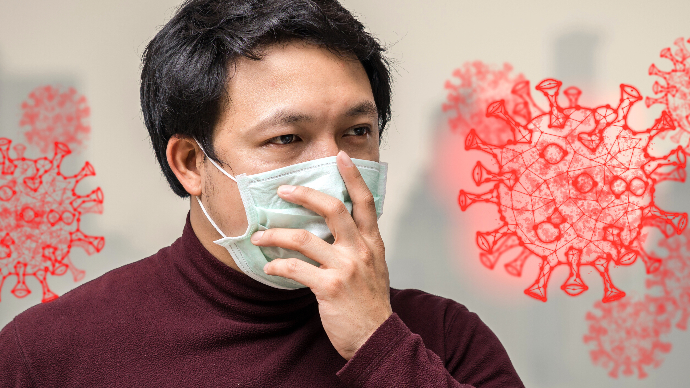 Man wearing a face mask showing signs of illness, symbolizing symptoms of COVID-19 in 2025 with virus icons in the background.