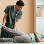 Home Physiotherapist assisting a woman with leg therapy during a physiotherapy session at home