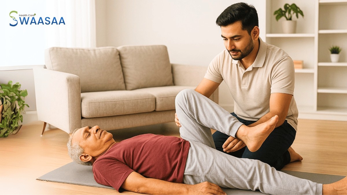 Indian physiotherapist providing personalized physiotherapy at home services to a senior patient lying on a mat.