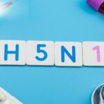 Injection, H5N1 tiles, stethoscope, and medicines symbolizing swine flu awareness and prevention